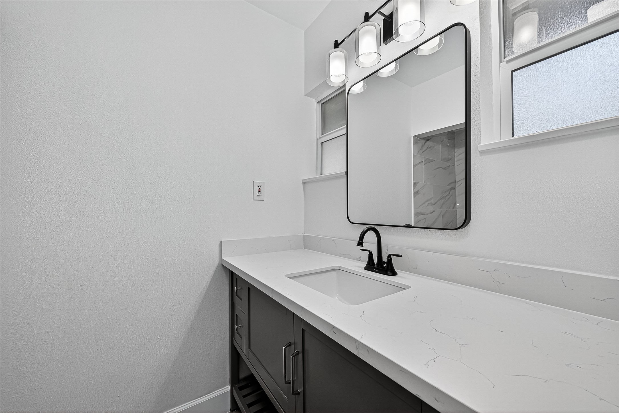 1609 North Pacific Street Conroe, TX 77301 - Photo 17 of 28 a bathroom with a sink and a mirror