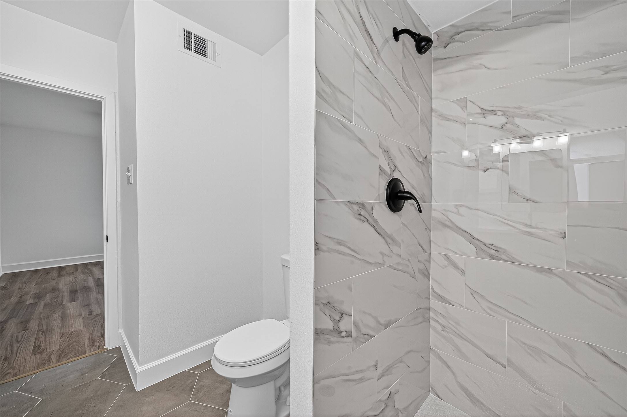 1609 North Pacific Street Conroe, TX 77301 - Photo 18 of 28 a bathroom with a granite countertop shower and a toilet