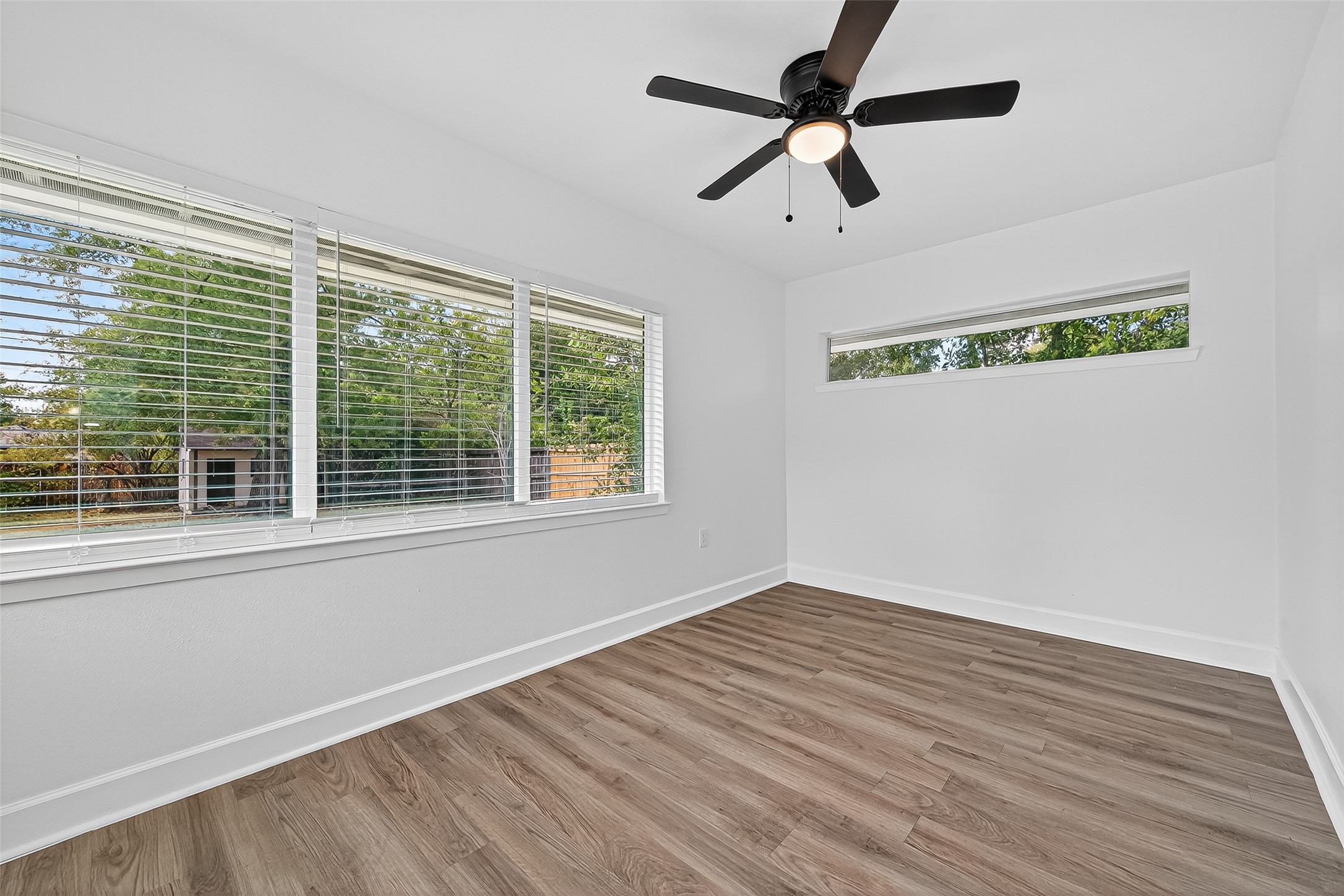 1609 North Pacific Street Conroe, TX 77301 - Photo 19 of 28 a view of empty room with wooden floor and fan