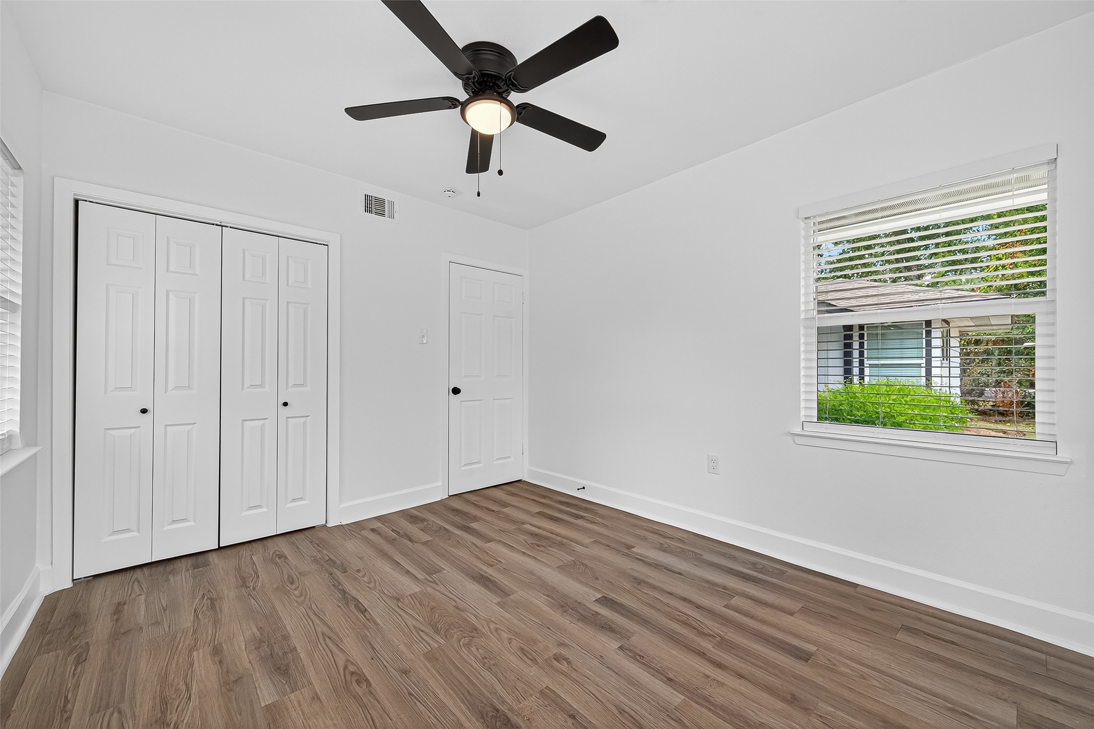 1609 North Pacific Street Conroe, TX 77301 - Photo 20 of 28 wooden floor in an empty room with a window