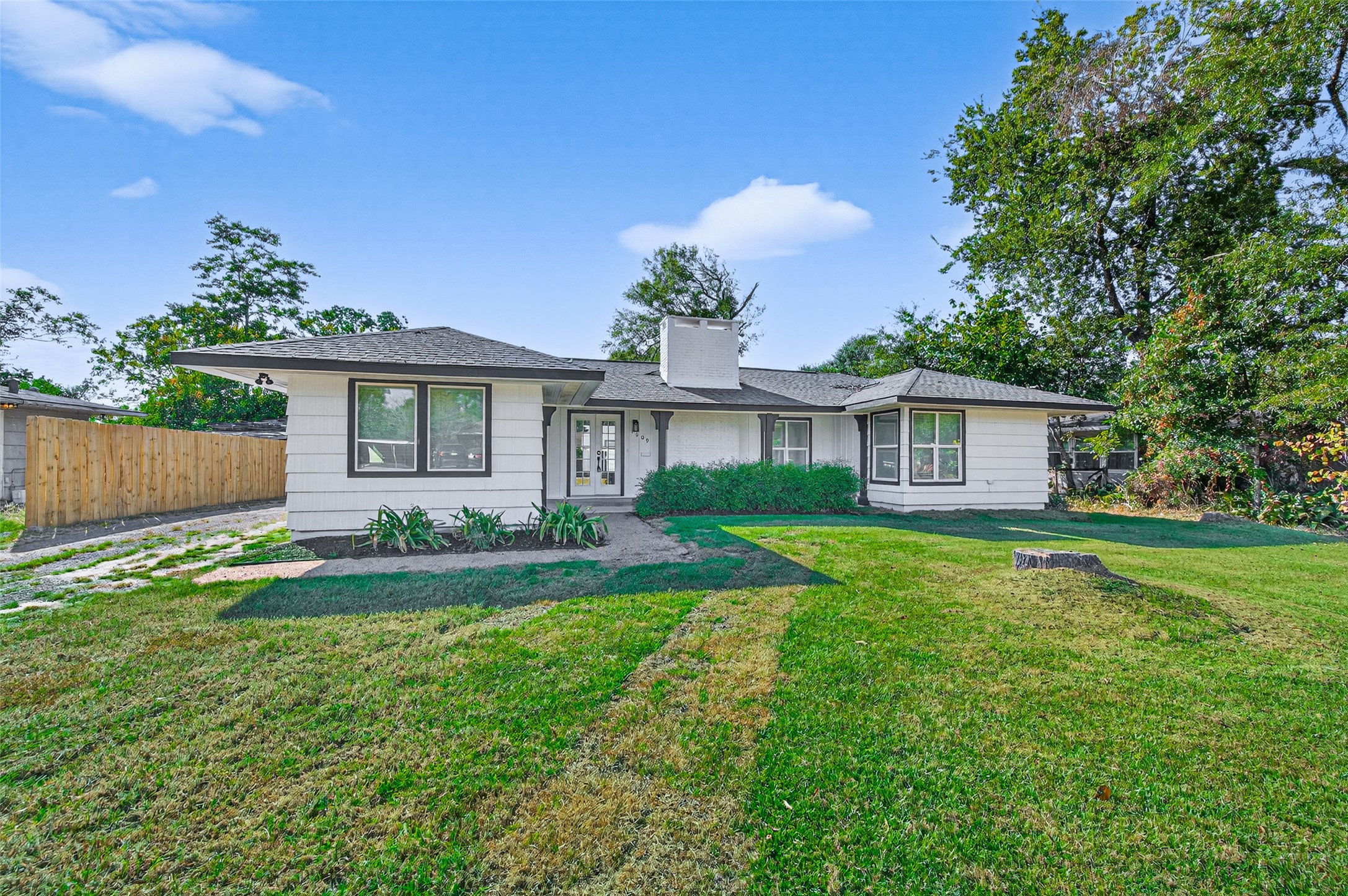 1609 North Pacific Street Conroe, TX 77301 - Photo 2 of 28 a front view of a house with a yard and garage