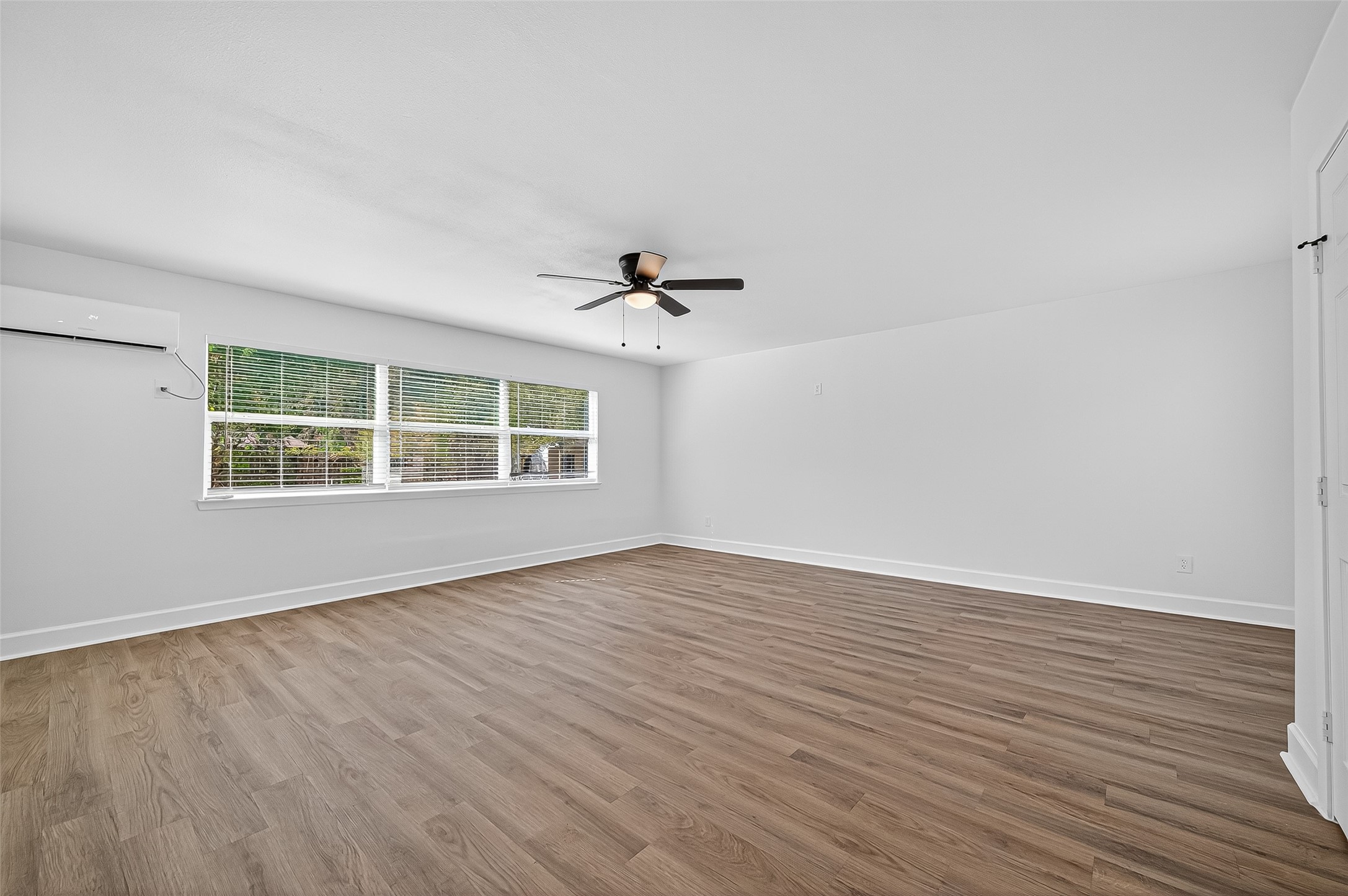 1609 North Pacific Street Conroe, TX 77301 - Photo 23 of 28 a view of an empty room with wooden floor and a window