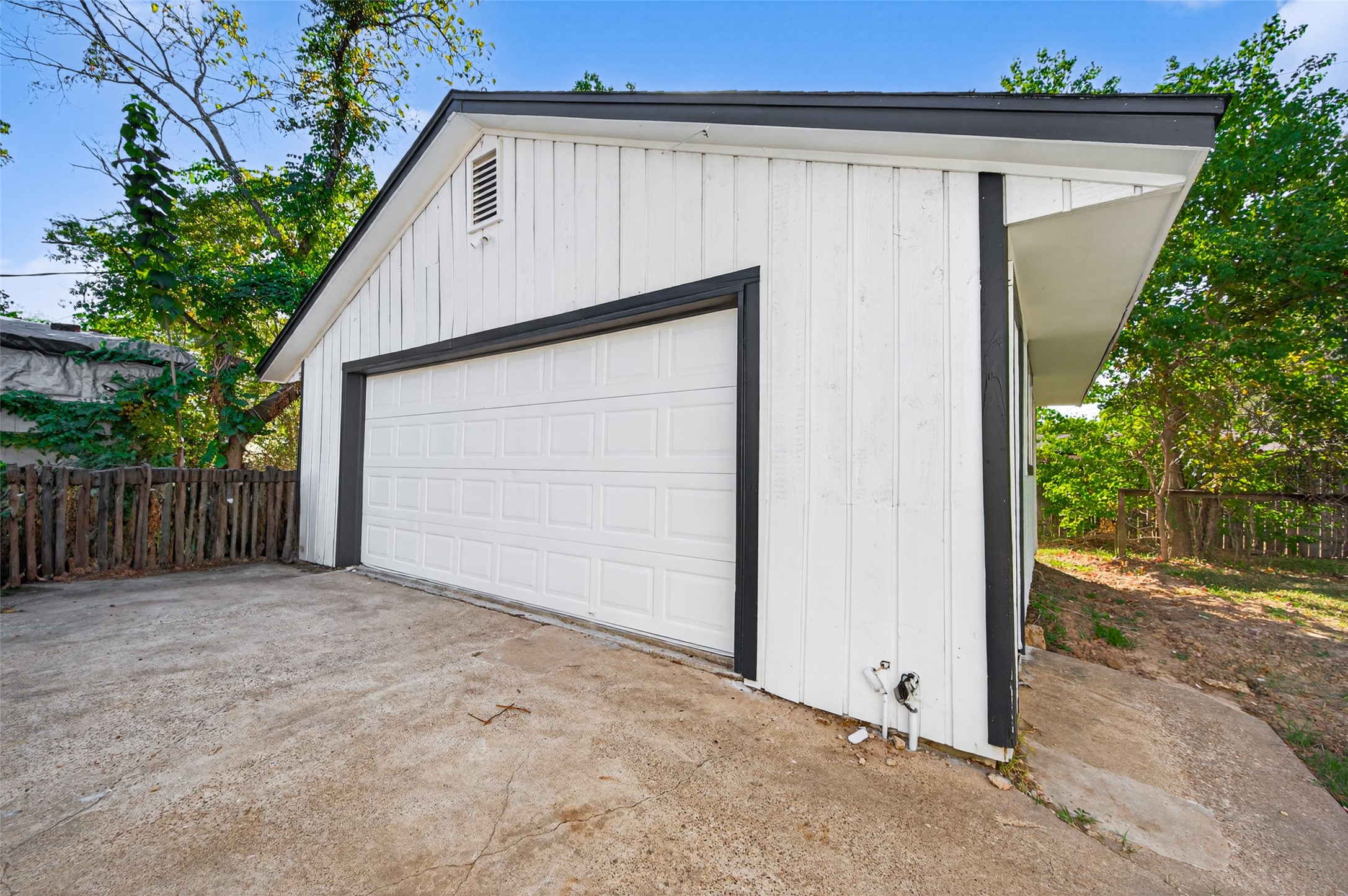 1609 North Pacific Street Conroe, TX 77301 - Photo 25 of 28 a view of backyard with small cabin and wooden fence