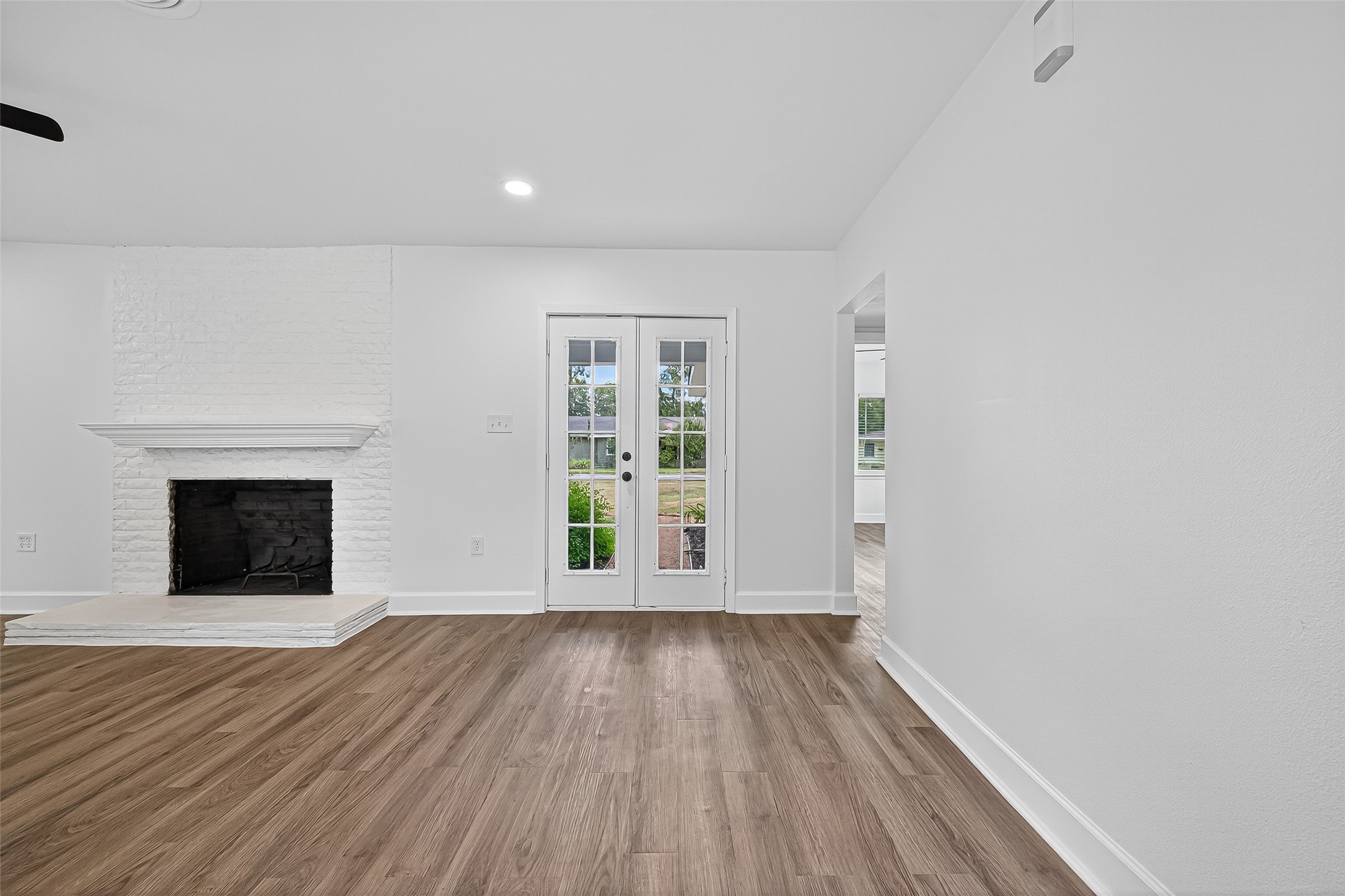 1609 North Pacific Street Conroe, TX 77301 - Photo 7 of 28 a view of an empty room with wooden floor and a window