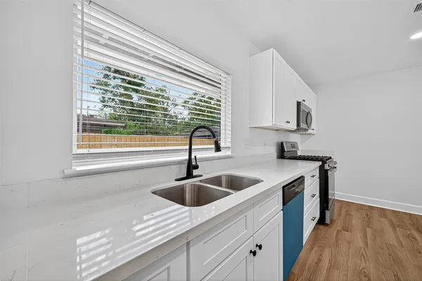 a kitchen with a sink and cabinets
