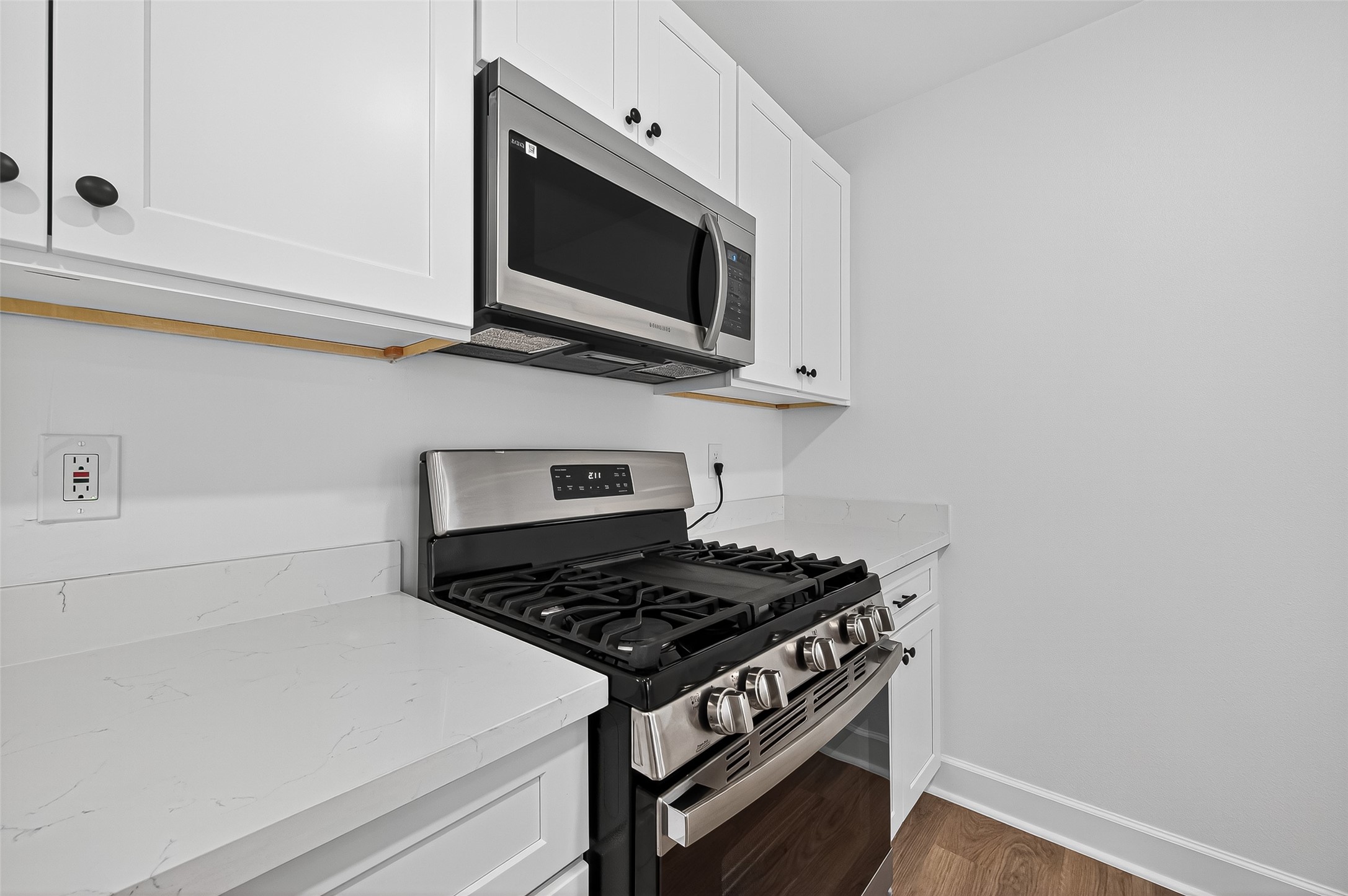 1609 North Pacific Street Conroe, TX 77301 - Photo 10 of 28 a stove top oven sitting inside of a kitchen
