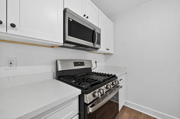 a stove top oven sitting inside of a kitchen