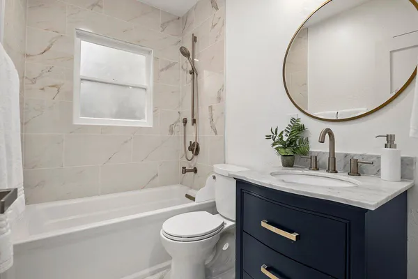 a bathroom with a sink a toilet and a mirror