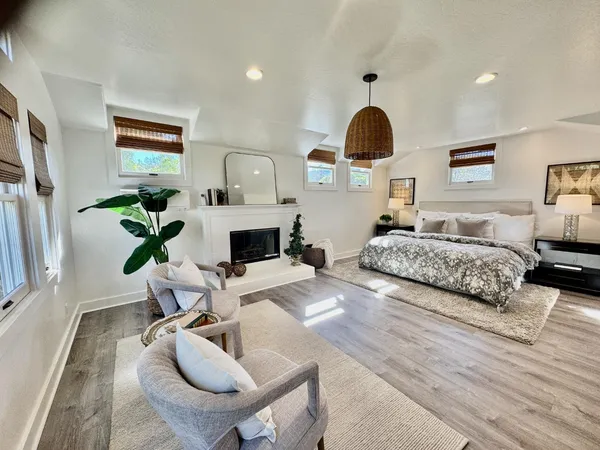 a living room with furniture a fireplace and decor