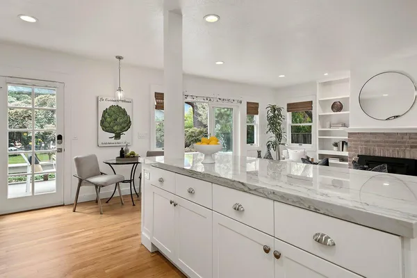 a kitchen with sink cabinets and living room view