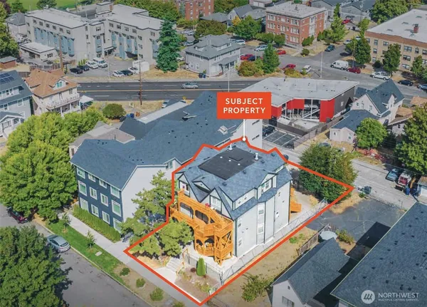 an aerial view of residential houses with outdoor space