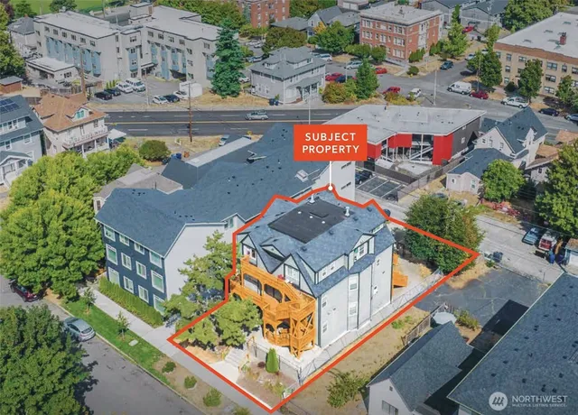 an aerial view of residential houses with outdoor space