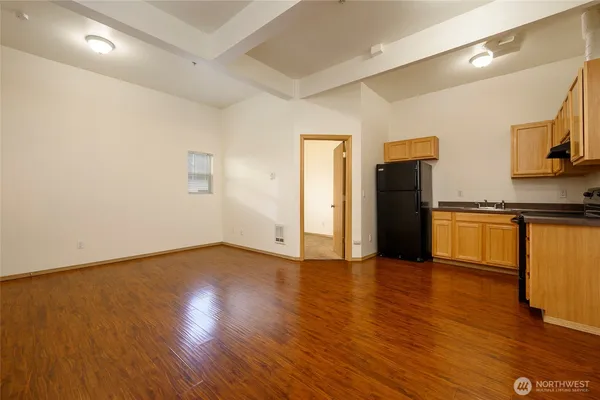 a view of kitchen with stainless steel appliances wooden floor and electronic appliances
