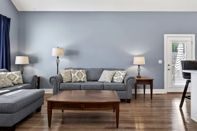 a view of a workspace with furniture and a window