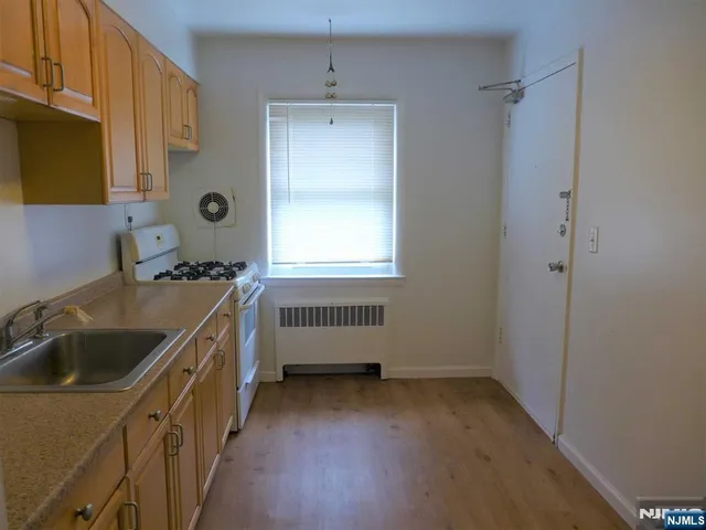a kitchen with a sink cabinets and window
