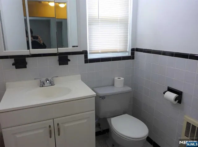 a bathroom with a toilet a sink and a window