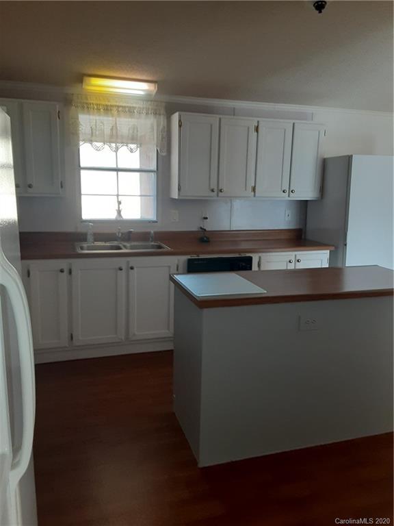 511 Daniels Ridge Road Taylorsville, NC 28681 - Photo 16 of 28 a kitchen with granite countertop white cabinets and a window