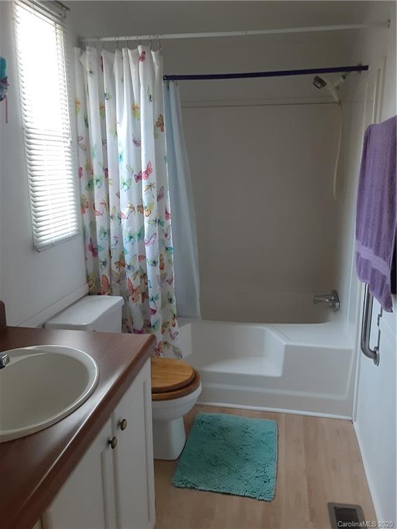 511 Daniels Ridge Road Taylorsville, NC 28681 - Photo 24 of 28 a bathroom with a sink a toilet a window and shower