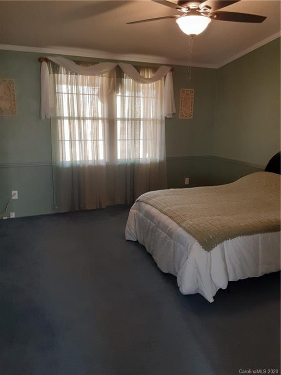 511 Daniels Ridge Road Taylorsville, NC 28681 - Photo 26 of 28 a bed sitting in a bedroom next to a window