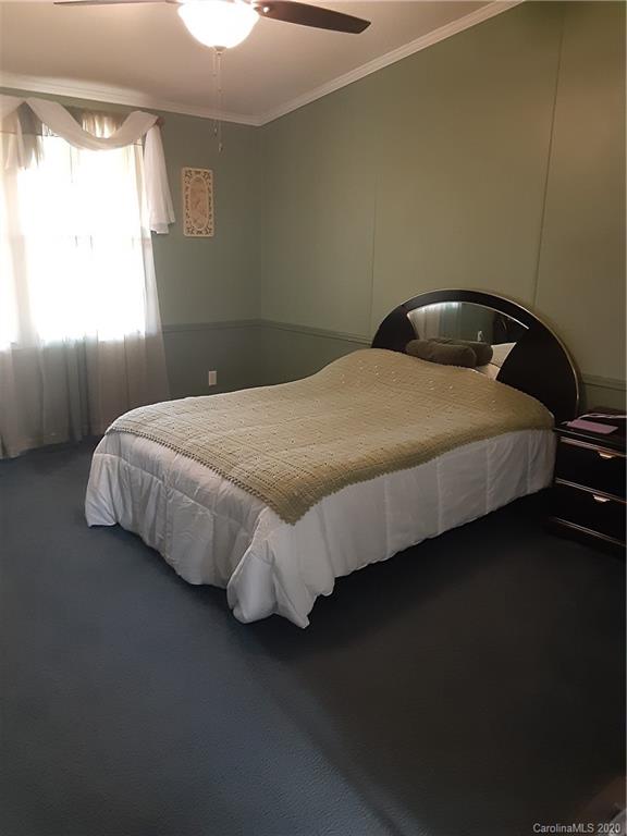 511 Daniels Ridge Road Taylorsville, NC 28681 - Photo 27 of 28 a bed sitting in a bedroom next to a window