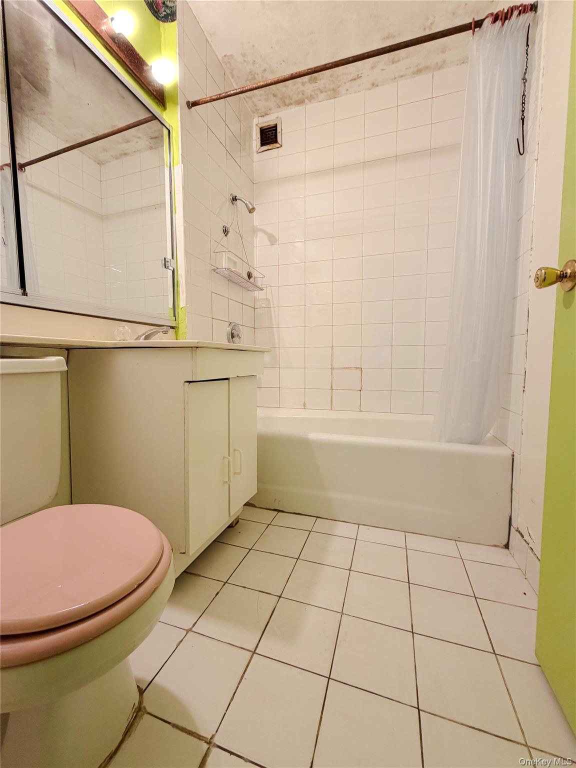 520 West 112th Street, Unit 4B Manhattan, NY 10025 - Photo 7 of 11 Full bathroom featuring vanity, shower / tub combo with curtain, and light tile patterned floors