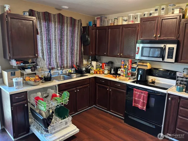 a kitchen that has a lot of cabinets a sink and a counter space