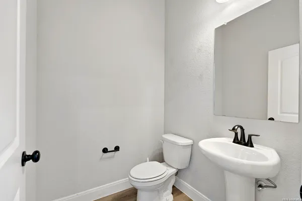 a white toilet sitting next to a white sink