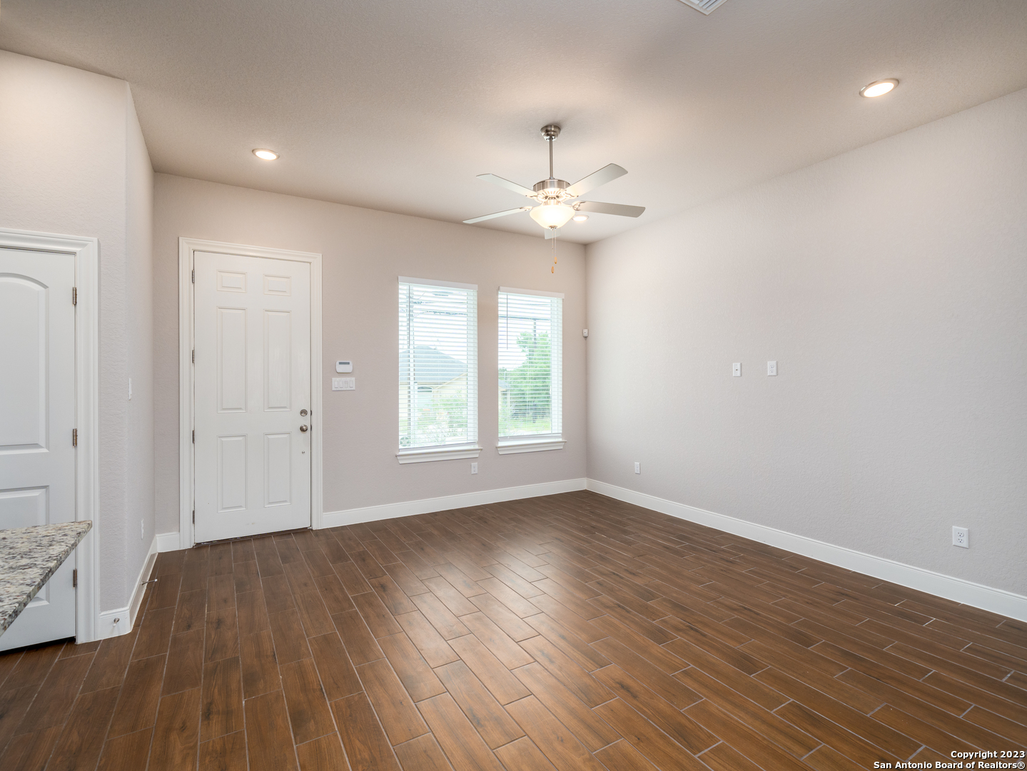 361 High Drive, Unit A Spring Branch, TX 78070 - Photo 8 of 20 an empty room with wooden floor and windows