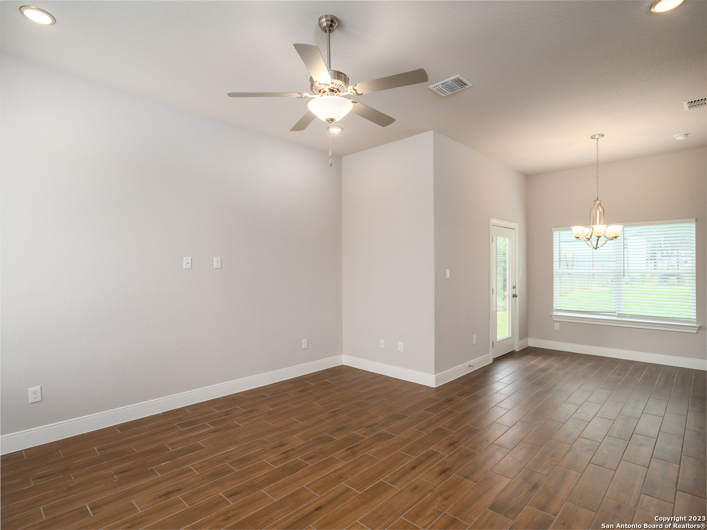 361 High Drive, Unit A Spring Branch, TX 78070 - Photo 9 of 20 an empty room with wooden floor fan and windows