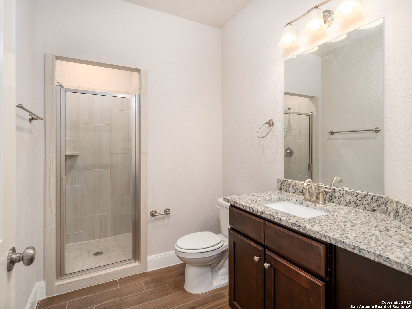 361 High Drive, Unit A Spring Branch, TX 78070 - Photo 10 of 20 a bathroom with a granite countertop sink toilet and shower