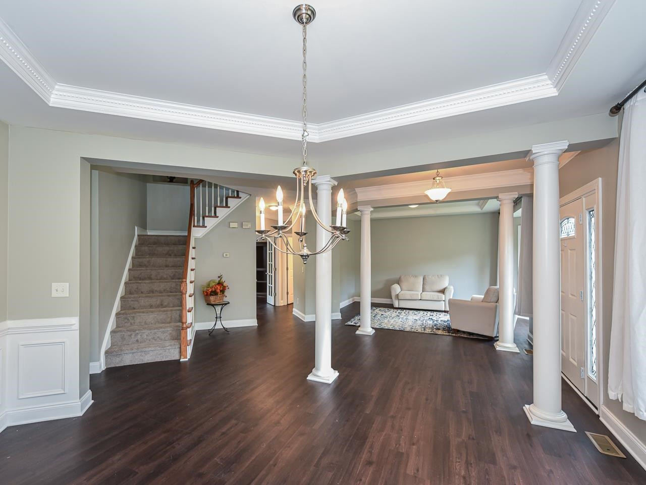200 Quarryrock Road Holly Springs, NC 27540 - Photo 13 of 39 a dining room with wooden floor a chandelier a glass table and chairs