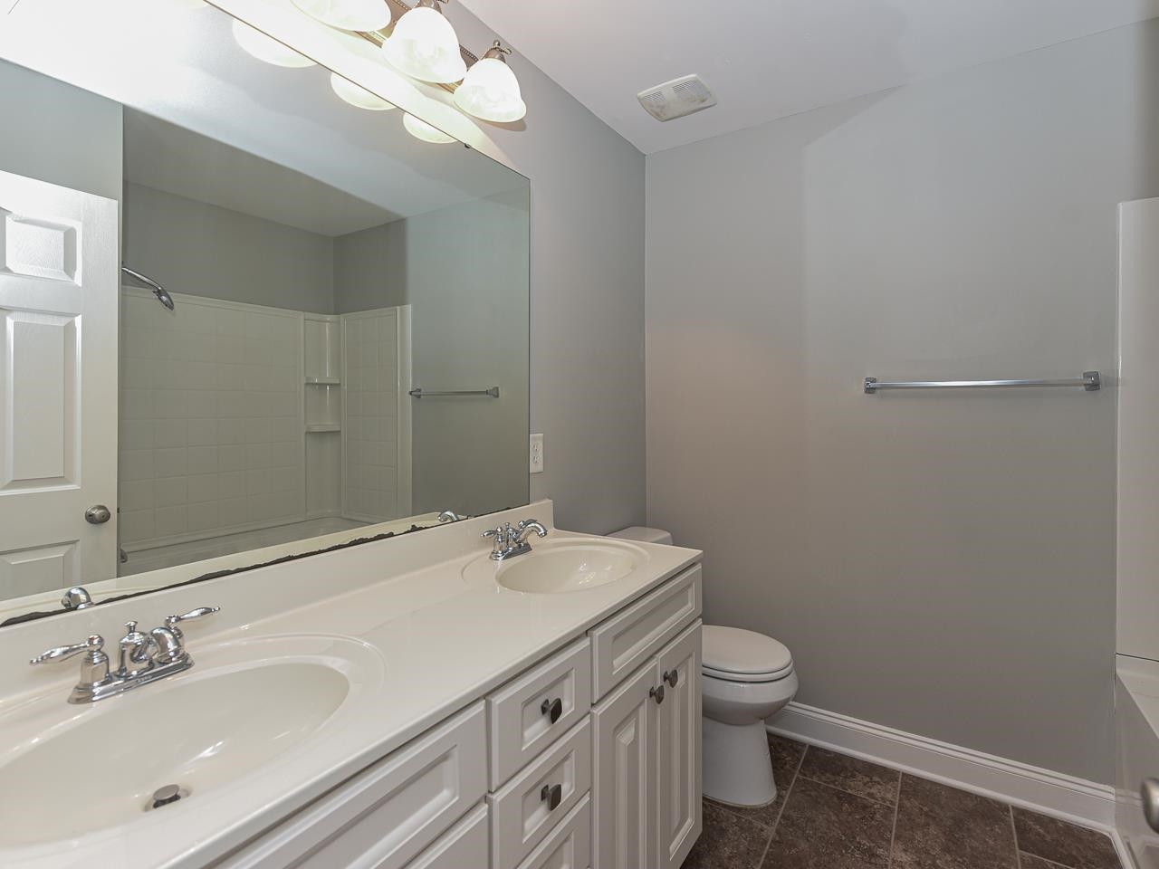 200 Quarryrock Road Holly Springs, NC 27540 - Photo 30 of 39 a bathroom with a granite countertop sink a toilet and a mirror