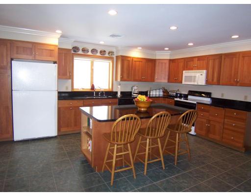 11 Georgianna Road Billerica, MA 01821 - Photo 11 of 29 a kitchen with stainless steel appliances granite countertop a stove a sink a refrigerator a dining table and chairs