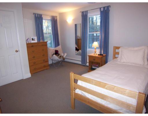 11 Georgianna Road Billerica, MA 01821 - Photo 24 of 29 a bedroom with a bed and a chandelier