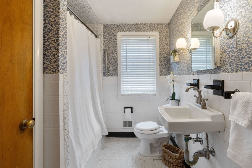 19 Laconia Road Natick, MA 01760 - Photo 16 of 27 a bathroom with a sink a toilet and a mirror