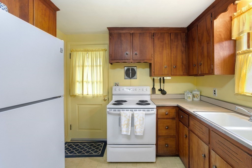 19 Laconia Road Natick, MA 01760 - Photo 8 of 27 a kitchen with a sink a stove and cabinets