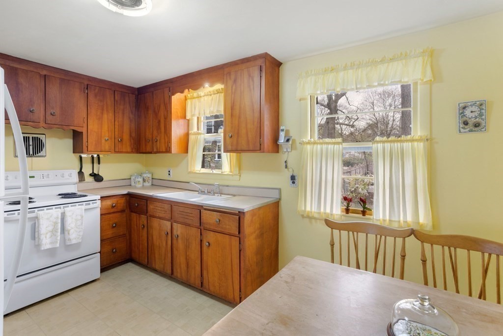 19 Laconia Road Natick, MA 01760 - Photo 10 of 27 a kitchen with a stove a sink and a refrigerator