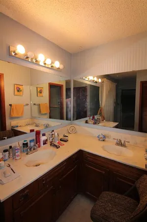 a living room with furniture a fireplace and a chandelier