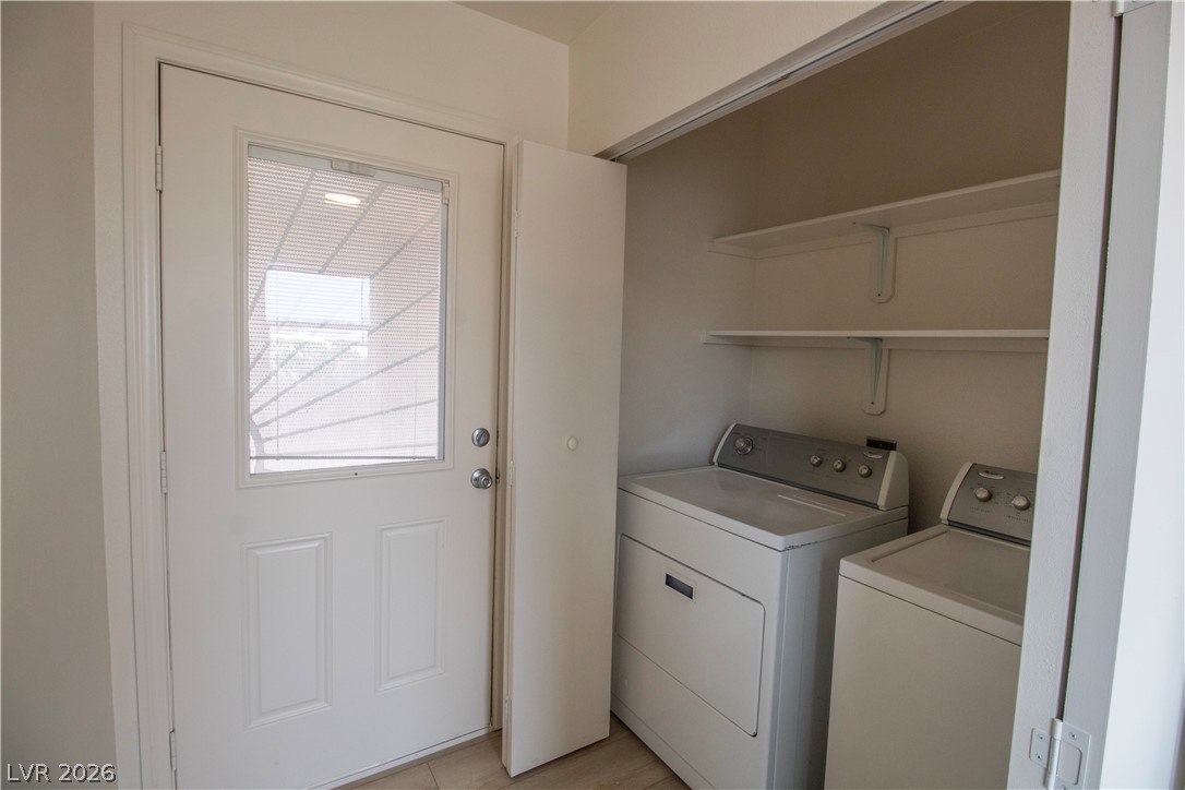119 West Victory Road Henderson, NV 89015 - Photo 8 of 26 Functional laundry nook adjacent to a bright entry door with integrated blinds.