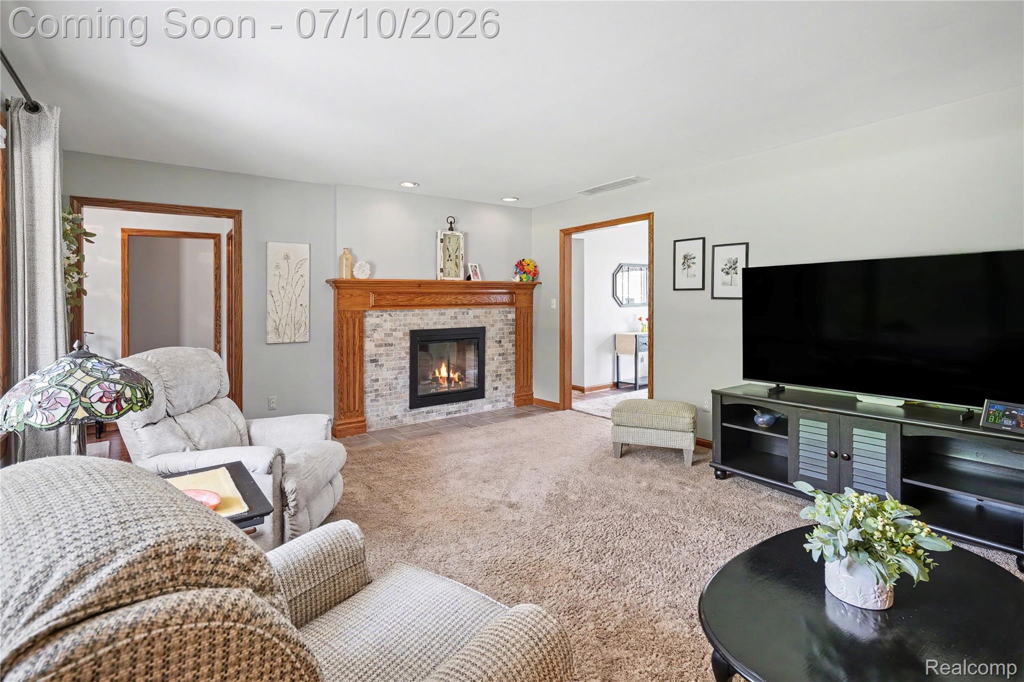 2180 Hurst Road St. Clair, MI 48079 - Photo 6 of 39 Living area featuring a fireplace with a light-colored brick surround and wood mantel