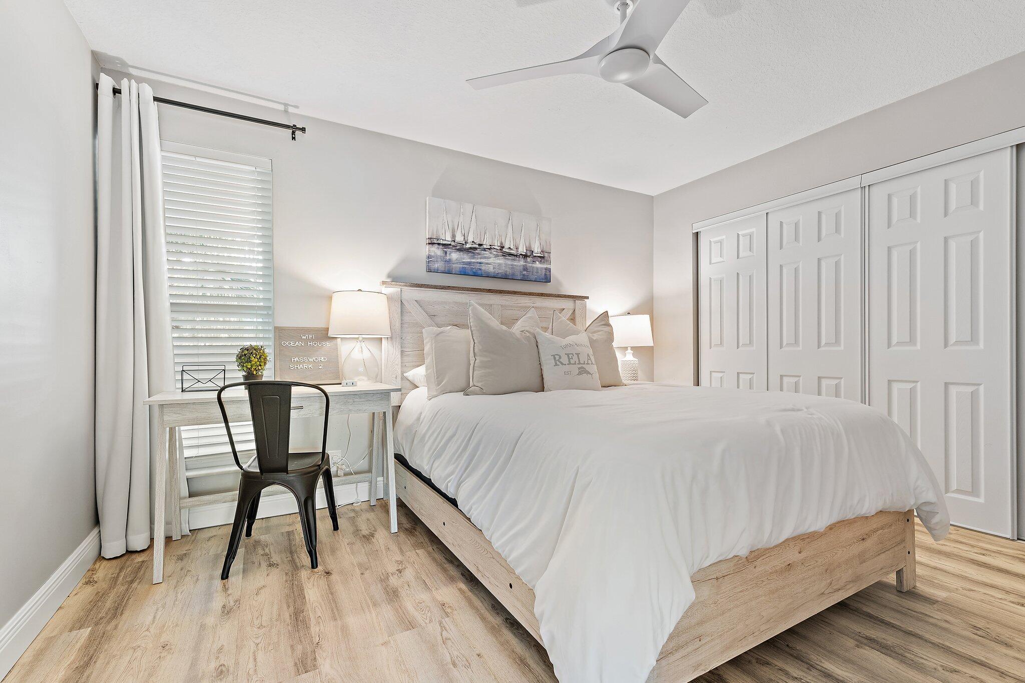 1605 Highway 1, Unit 209M2 Jupiter, FL 33477 - Photo 13 of 26 a bedroom with a bed a mirror and a window