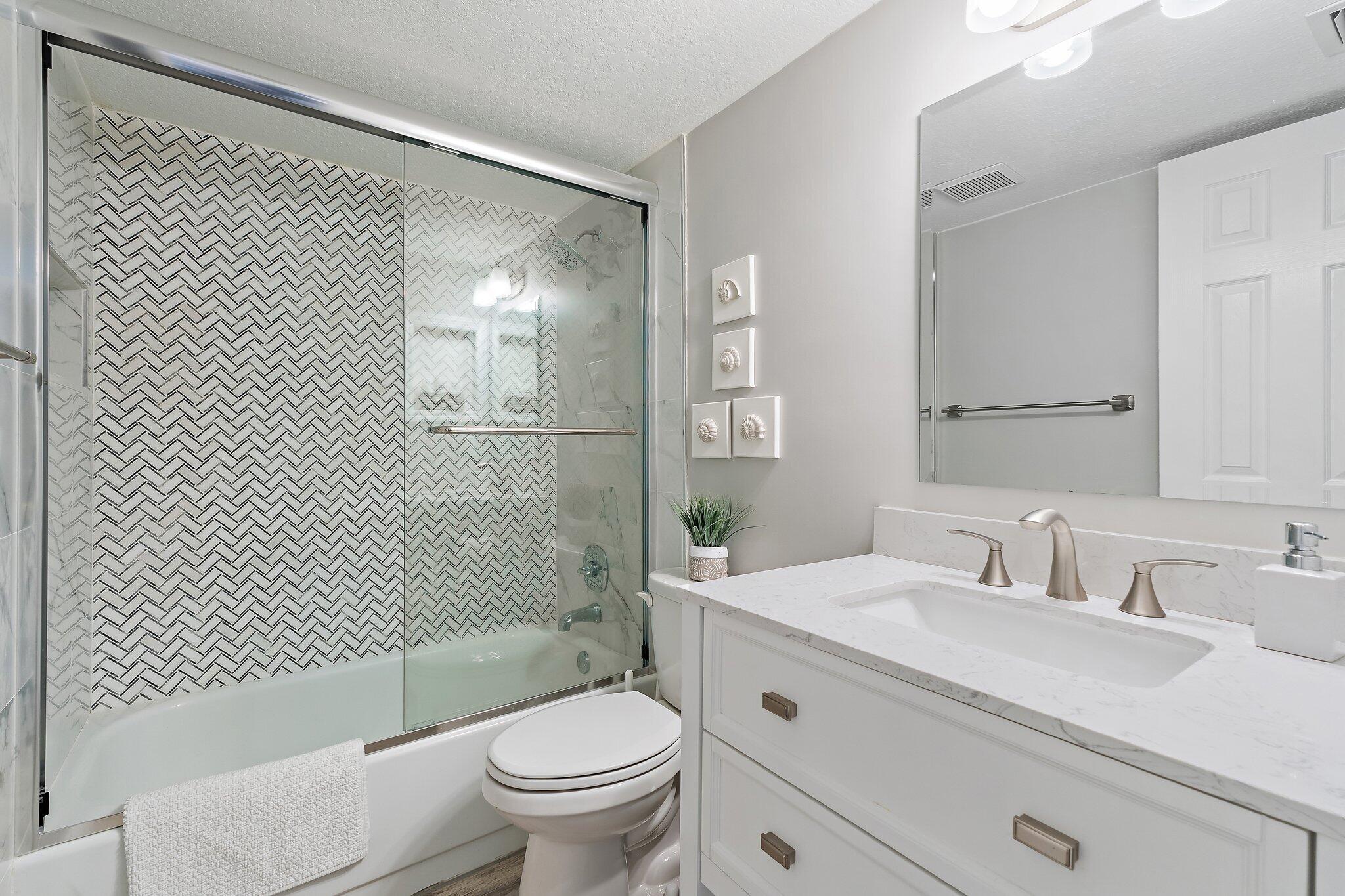 1605 Highway 1, Unit 209M2 Jupiter, FL 33477 - Photo 15 of 26 a bathroom with a sink toilet and shower