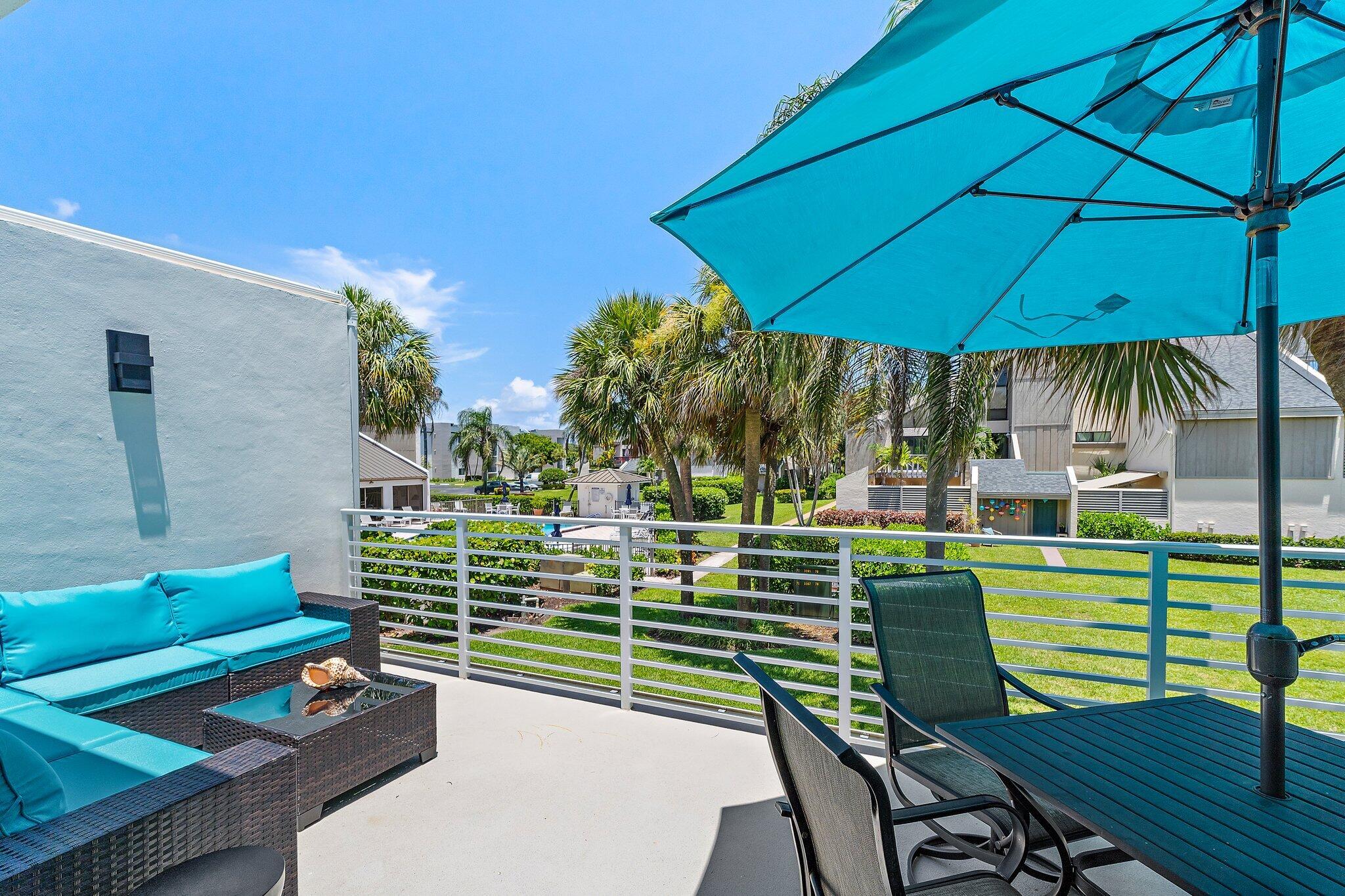 1605 Highway 1, Unit 209M2 Jupiter, FL 33477 - Photo 16 of 26 a view of a chairs and table in the patio