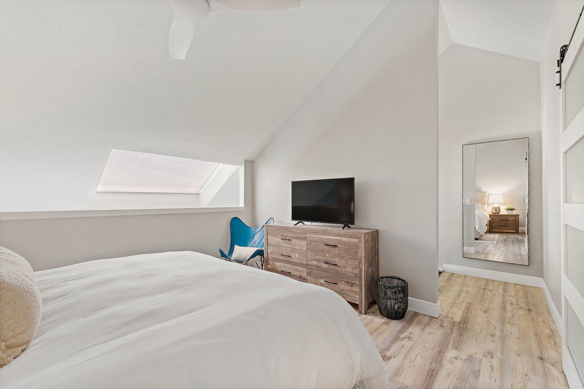 1605 Highway 1, Unit 209M2 Jupiter, FL 33477 - Photo 19 of 26 a bedroom with a bed and a flat screen tv