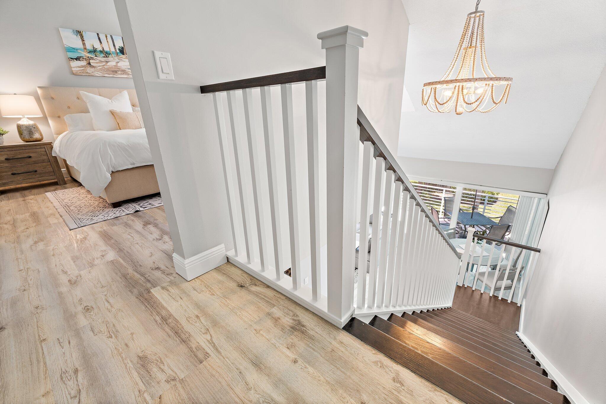 1605 Highway 1, Unit 209M2 Jupiter, FL 33477 - Photo 22 of 26 a view of staircase with white walls and wooden floor