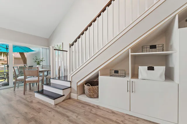 a view of entryway and hall with wooden floor