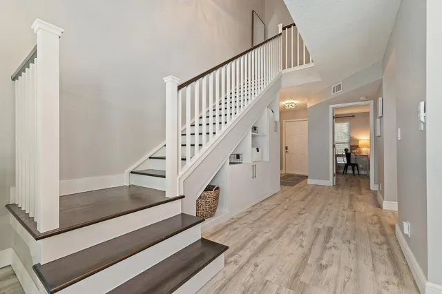 a view of entryway and hall with wooden floor
