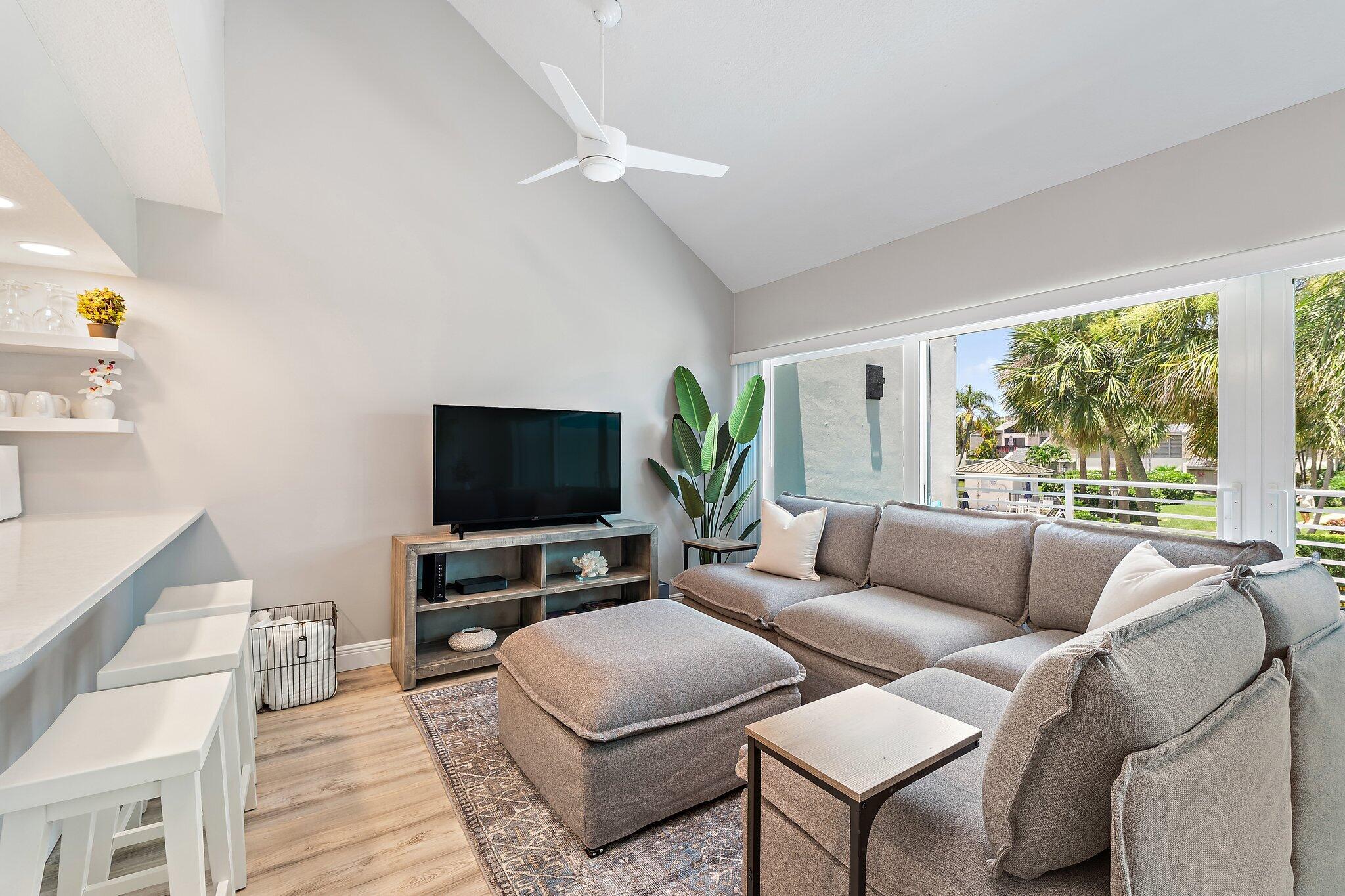1605 Highway 1, Unit 209M2 Jupiter, FL 33477 - Photo 7 of 26 a living room with furniture and a flat screen tv
