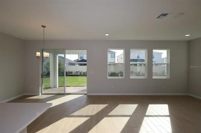 an empty room with windows and outdoor view