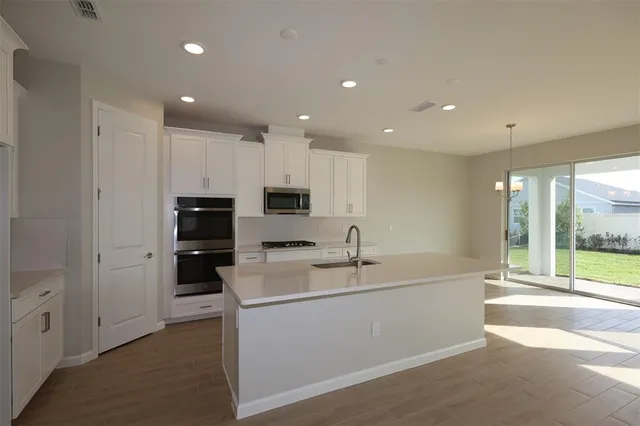 a kitchen with a sink stainless steel appliances and cabinets